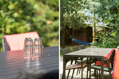 a picnic table with glasses and a table with chairs at 242-Thisted-Muslingevej-4 in Thisted