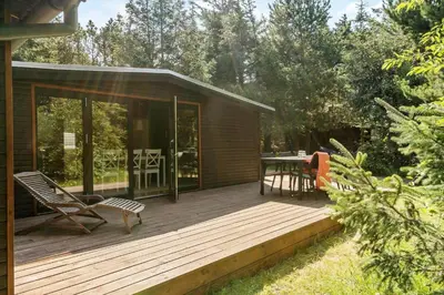 a wooden deck with a table and chairs on it at 242-Thisted-Muslingevej-4 in Thisted