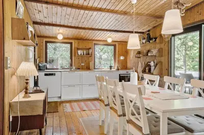 a kitchen and dining room with a table and chairs at 242-Thisted-Muslingevej-4 in Thisted