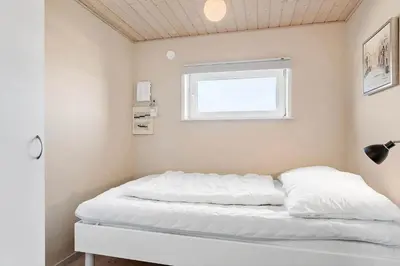 a white bed in a room with a window at 870-Thisted-Nordsovej-34 in Thisted