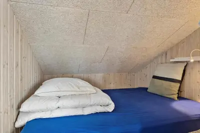 a bed in a room with a ceiling at 1059-Klitmoller-Mollebakken-56 in Klitmøller