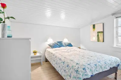 a white bedroom with a bed with blue pillows at 388-Thisted-Hummervej-8 in Thisted