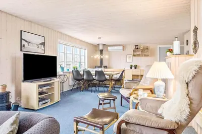a living room with a television and a dining room at 388-Thisted-Hummervej-8 in Thisted