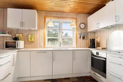 a kitchen with white cabinets and a window at 930-Thisted-Liusborg-Sti-28 in Torsted