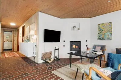 a living room with a table and a fireplace at 930-Thisted-Liusborg-Sti-28 in Torsted