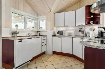 a kitchen with white cabinets and white appliances at 858-Thisted-Delfinvej-24 in Thisted