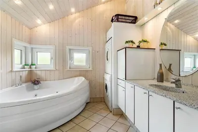 a bathroom with a large white tub and a sink at 858-Thisted-Delfinvej-24 in Thisted