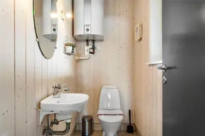 a bathroom with a sink and a toilet and a mirror at 858-Thisted-Delfinvej-24 in Thisted