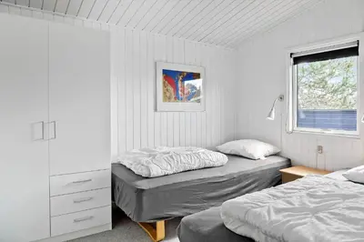 a bedroom with two beds and a window at 596-Thisted-Blabaervej-15 in Thisted