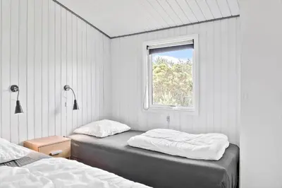 a bedroom with two beds and a window at 596-Thisted-Blabaervej-15 in Thisted
