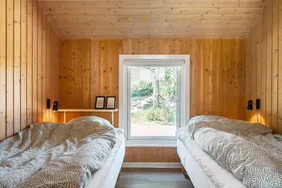 two beds in a room with a window at 209-Vestervig-Isfuglevej-15 in Vestervig
