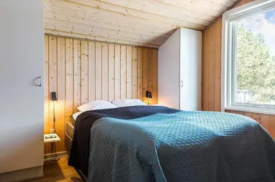 a bedroom with a bed in a room with a window at 209-Vestervig-Isfuglevej-15 in Vestervig
