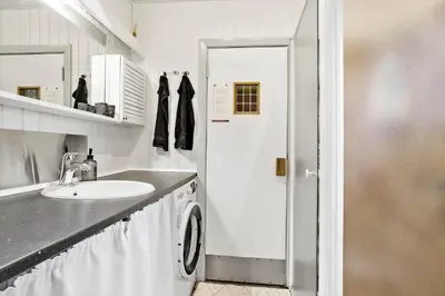 a white bathroom with a sink and a washing machine at 118-Vestervig-Sivsangervej-18 in Vestervig