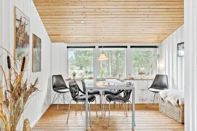 a dining room with a table and chairs at 118-Vestervig-Sivsangervej-18 in Vestervig