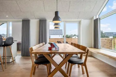 a dining room with a wooden table and chairs at 1300-Thisted-Smedevej-3-B in Thisted