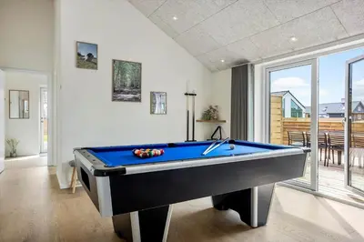 a pool table in a room with a large window at 1300-Thisted-Smedevej-3-B in Thisted