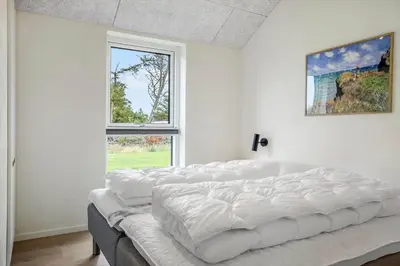 a bedroom with white walls and a large bed at 1300-Thisted-Smedevej-3-B in Thisted