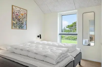 a large bed in a room with a window at 1300-Thisted-Smedevej-3-B in Thisted