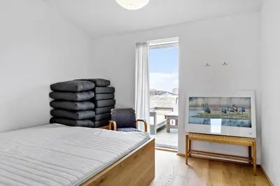 a bedroom with a bed with a pile of towels at 926-Thisted-Niels-Vognmands-Vej-15 in Torsted