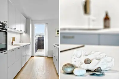 a kitchen with white cabinets and a counter with rocks on the floor at 926-Thisted-Niels-Vognmands-Vej-15 in Torsted