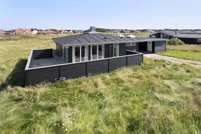 a black house in a field of grass at 926-Thisted-Niels-Vognmands-Vej-15 in Torsted