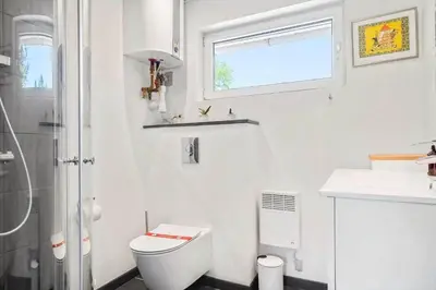 a white bathroom with a toilet and a sink at 420-Vestervig-Kanalvej-4 in Vestervig