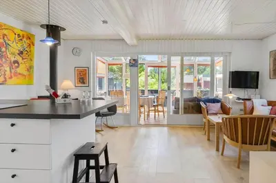a kitchen and living room with a table and chairs at 420-Vestervig-Kanalvej-4 in Vestervig