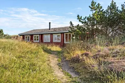 a house sitting on top of a hill with a dirt road at 651-Snedsted-Somaerkevej-50 in Snedsted