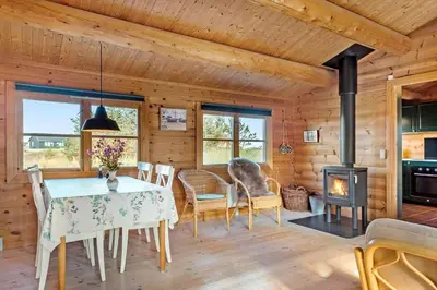 a dining room with a table and a stove at 651-Snedsted-Somaerkevej-50 in Snedsted