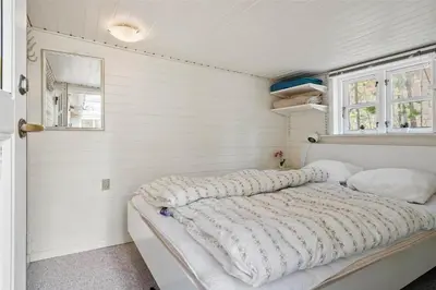 a bed in a room with white walls at 727-Thisted-Blamunkevej-11 in Thisted