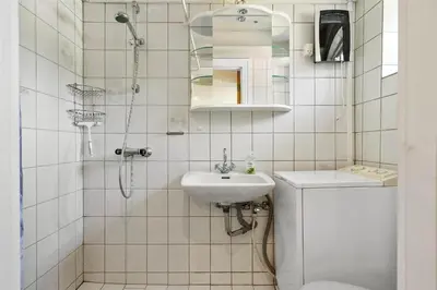 a white bathroom with a sink and a shower at 727-Thisted-Blamunkevej-11 in Thisted