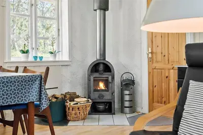 a living room with a wood stove in a room at 727-Thisted-Blamunkevej-11 in Thisted