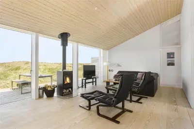 a living room with a couch and a fireplace at 768-Snedsted-Somaerkevej-68 in Snedsted