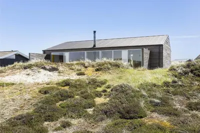 a house on top of a hill with grass at 768-Snedsted-Somaerkevej-68 in Snedsted