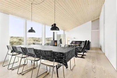 a dining room with a large table and chairs at 768-Snedsted-Somaerkevej-68 in Snedsted