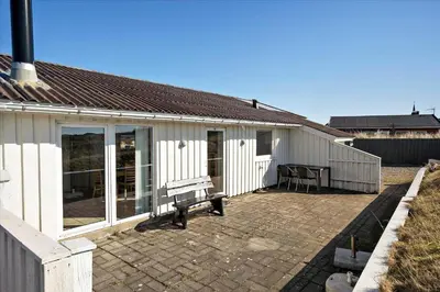 a white house with a bench in front of it at 608-Thisted-Vesterhavsgade-49-A in Thisted
