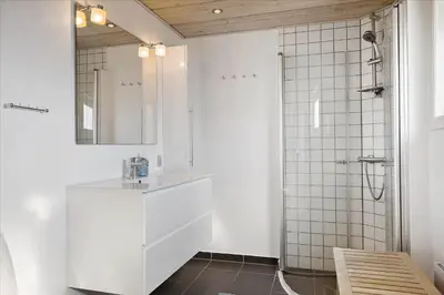a white bathroom with a sink and a shower at 608-Thisted-Vesterhavsgade-49-A in Thisted