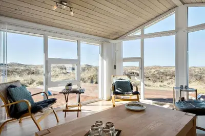a living room with a table and chairs and large windows at 608-Thisted-Vesterhavsgade-49-A in Thisted