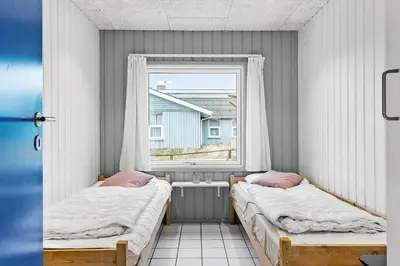 two beds in a room with a window at 975-Thisted-Klitstien-45 in Torsted