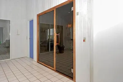 a glass door in a room with a tile floor at 975-Thisted-Klitstien-45 in Torsted