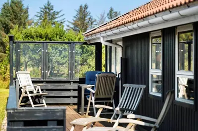a group of chairs sitting on the deck of a house at 675-Thisted-Tunvej-15 in Thisted