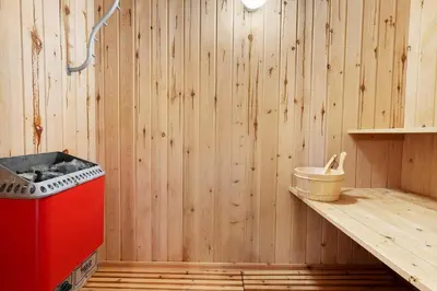 a kitchen with a red stove and a wooden wall at 675-Thisted-Tunvej-15 in Thisted