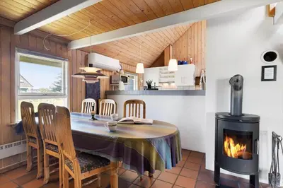 a dining room with a table and a fireplace at 675-Thisted-Tunvej-15 in Thisted