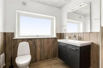a bathroom with a toilet and a sink and a mirror at 899-Snedsted-Somaerkevej-76-B in Snedsted