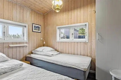 a bedroom with two beds and two windows at 1030-Thisted-Lyngstien-15-A in Torsted