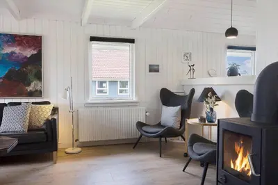 a living room with chairs and a fireplace at 446-Thisted-Nordsovej-206-F in Thisted