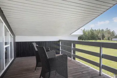 a porch with chairs on a wooden deck at 446-Thisted-Nordsovej-206-F in Thisted