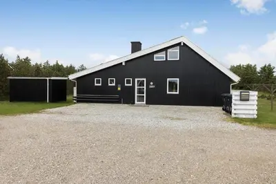 a black barn with a gravel driveway in front of it at 446-Thisted-Nordsovej-206-F in Thisted