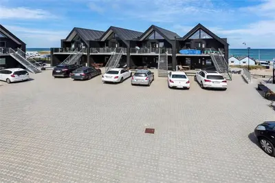 a parking lot with cars parked in front of a house at 791-Thisted-Havstokken-12-1 in Thisted