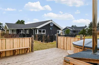 a backyard with a wooden deck and a house at 512-Thisted-Sotungevej-4 in Thisted